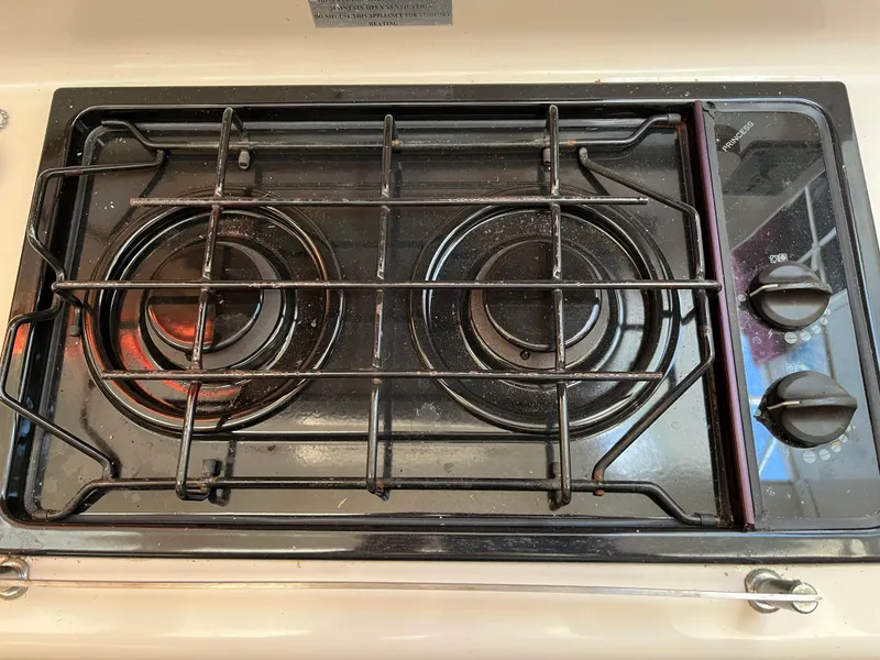 Slide: The Image of Two-burner PDQ 32 stove from 2003 with control knobs on the right. - 44