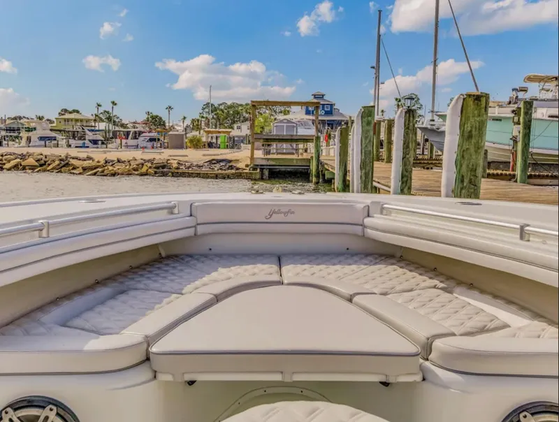 Slide: The Image of 2017 Yellowfin 36 Offshore boat with spacious seating, docked at a marina under a clear sky. - 18