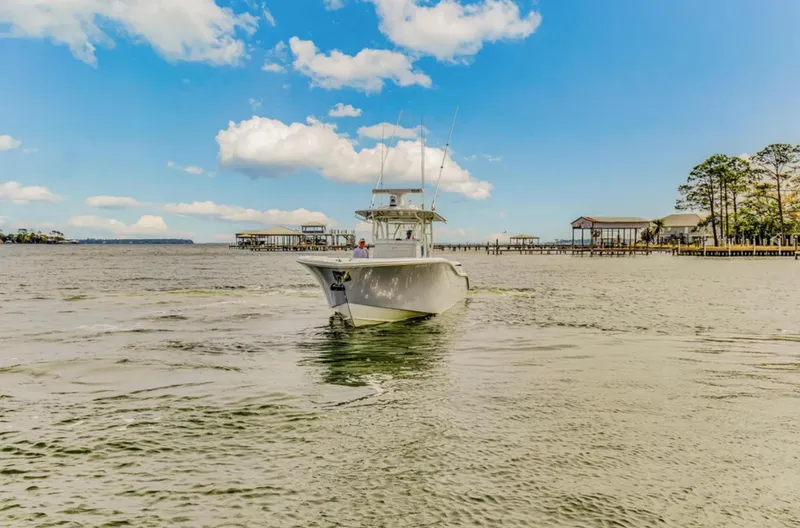 Slide: The Image of 2017 Yellowfin 36 Offshore boat cruising on a sunny day near docks. - 4