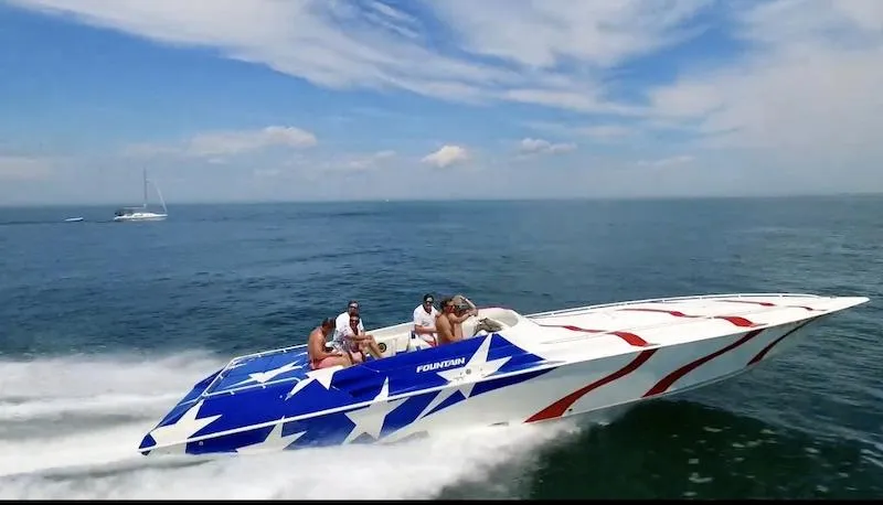 The Image of 1998 Fountain 42 Lightning speedboat with star-spangled design cruising on open water. - 1