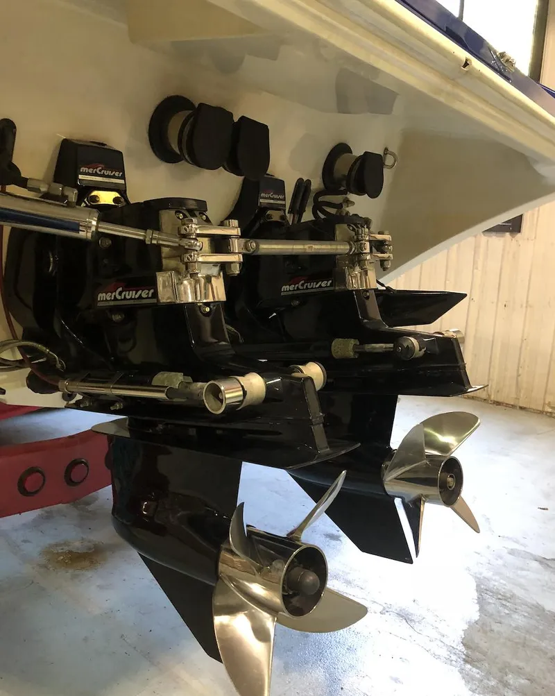 Slide: The Image of 1998 Fountain 42 Lightning boat with dual MerCruiser engines and propellers in a garage setting. - 11