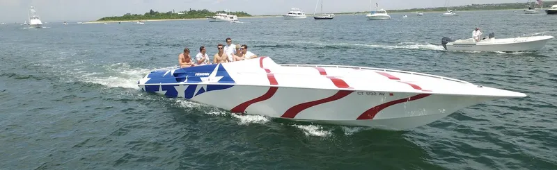 Slide: The Image of 1998 Fountain 42 Lightning speedboat with American flag design on open water. - 3