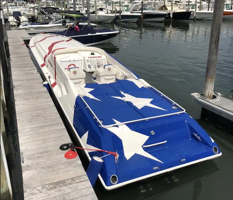 Slide: The Image of 1998 Fountain 42 Lightning speedboat with star-spangled design docked at marina. - 6