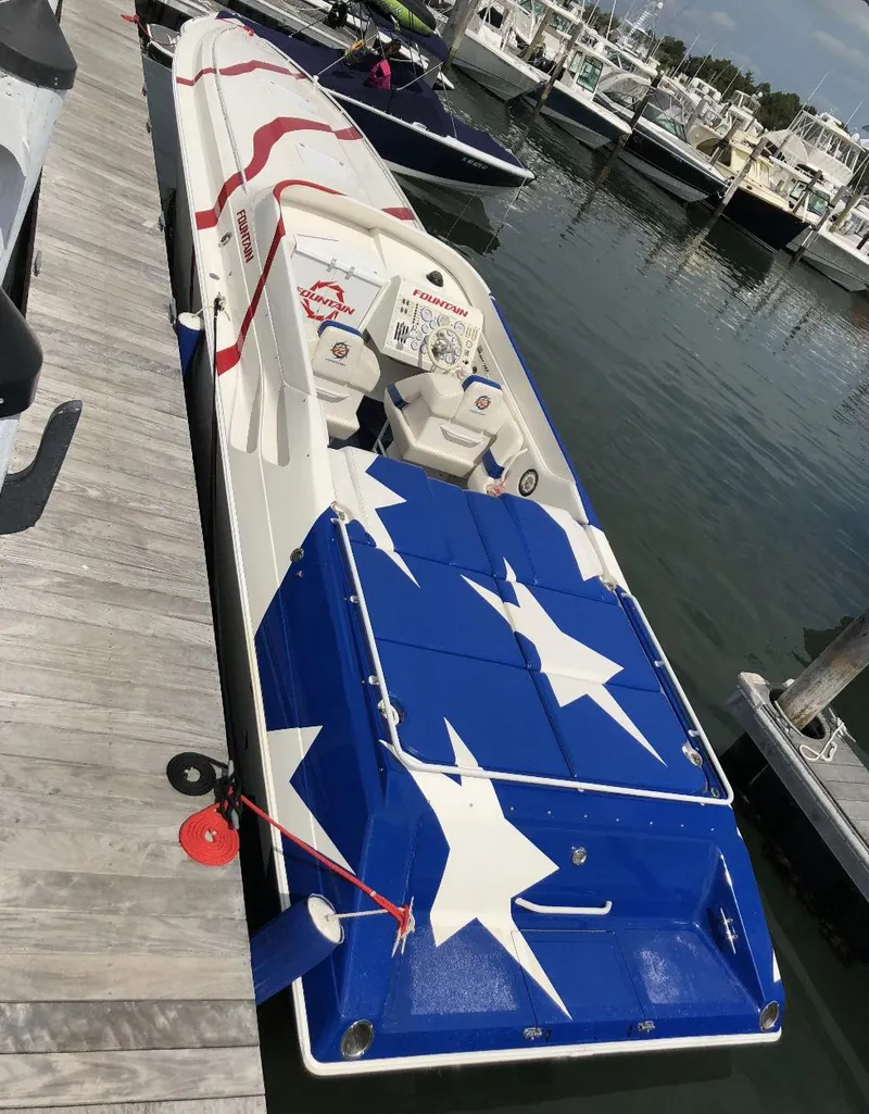 Slide: The Image of 1998 Fountain 42 Lightning boat with star-spangled design docked at marina. - 7