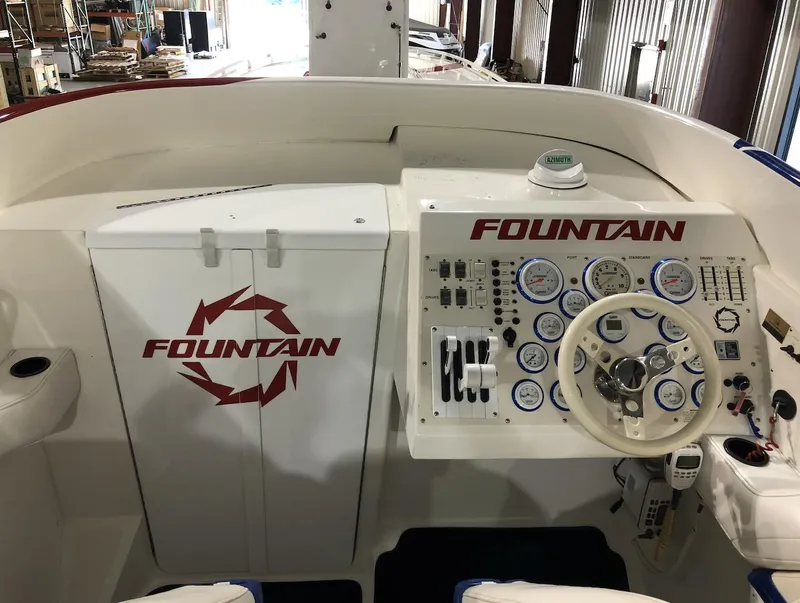 Slide: The Image of 1998 Fountain 42 Lightning boat dashboard with steering wheel and control panel. - 8