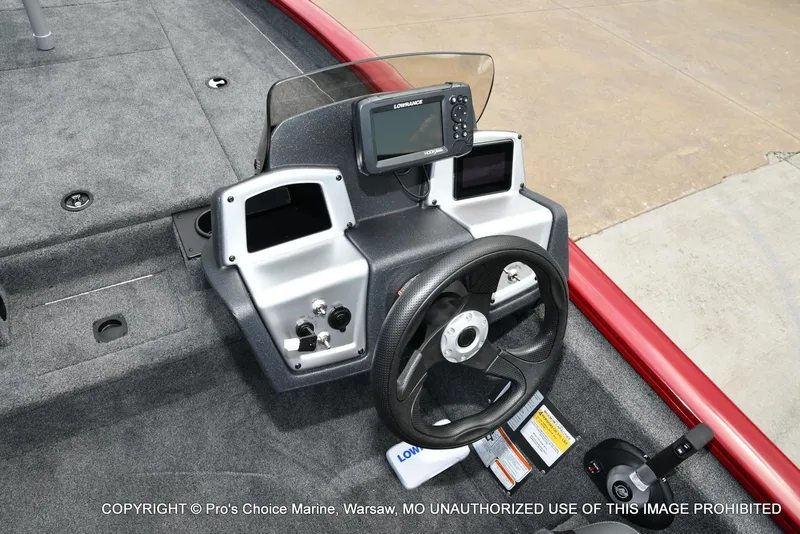 Slide: The Image of 2025 Tracker Pro Team 190 TX boat dashboard with steering wheel and navigation system. - 10