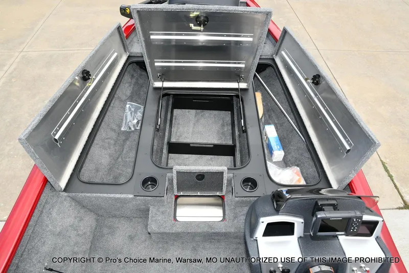 Slide: The Image of 2025 Tracker Pro Team 190 TX boat interior with open storage compartments and dashboard. - 11
