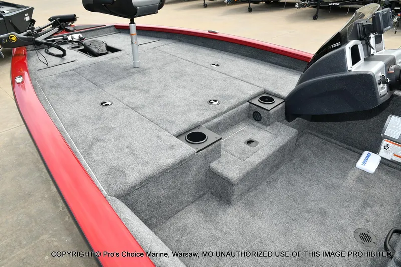 Slide: The Image of 2025 Tracker Pro Team 190 TX boat interior with gray carpet and red trim. - 14