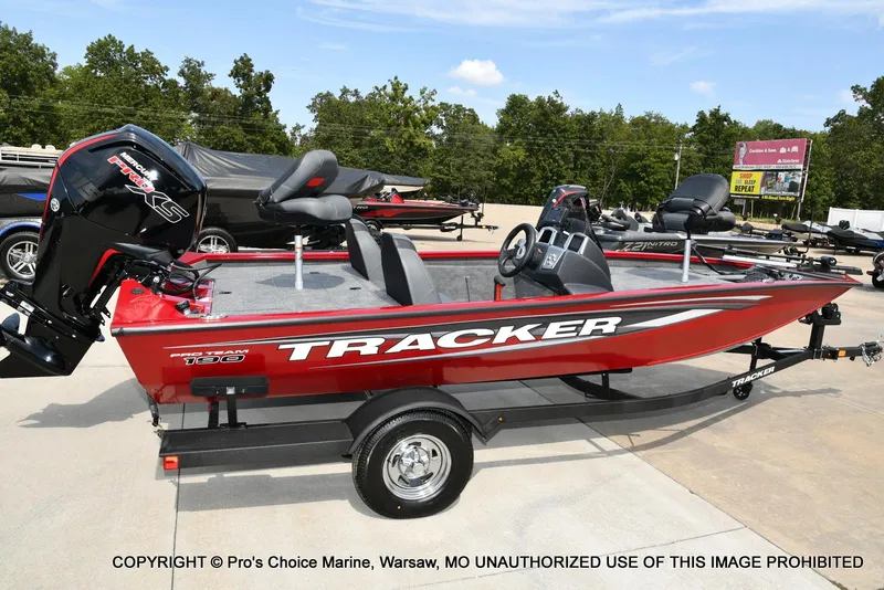 Slide: The Image of 2025 Tracker Pro Team 190 TX boat in red, parked on a trailer outdoors. - 18