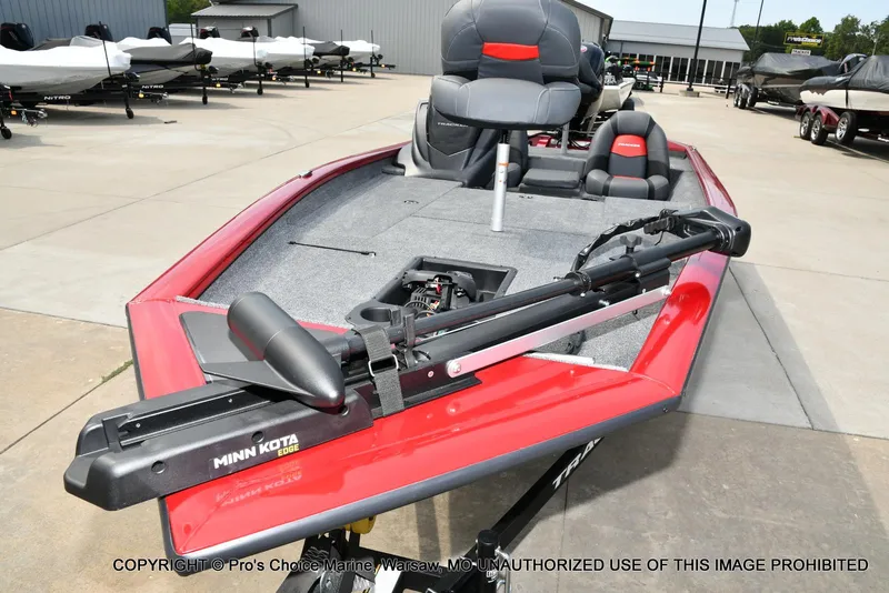 Slide: The Image of 2025 Tracker Pro Team 190 TX boat with Minn Kota trolling motor, displayed outdoors. - 27