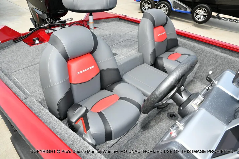 Slide: The Image of 2025 Tracker Pro Team 190 TX boat interior with gray and red seating. - 29