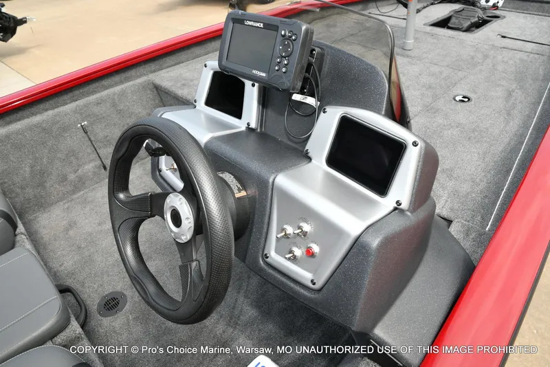 Slide: The Image of 2025 Tracker Pro Team 190 TX boat dashboard with steering wheel and electronic display. - 31