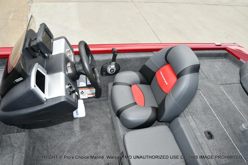 Slide: The Image of 2025 Tracker Pro Team 190 TX boat interior with steering console and cushioned seat. - 35