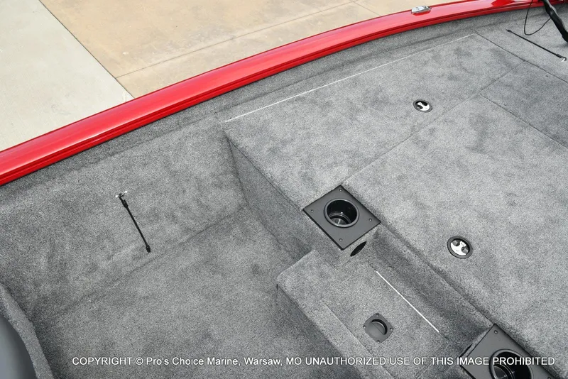Slide: The Image of 2025 Tracker Pro Team 190 TX boat interior with gray carpet and red trim. - 38