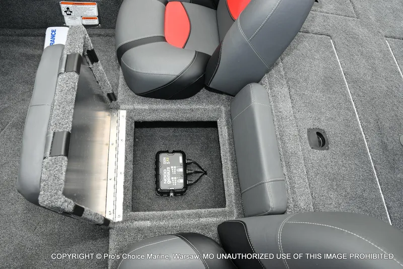 Slide: The Image of Interior of 2025 Tracker Pro Team 190 TX boat with storage compartment and battery charger. - 45