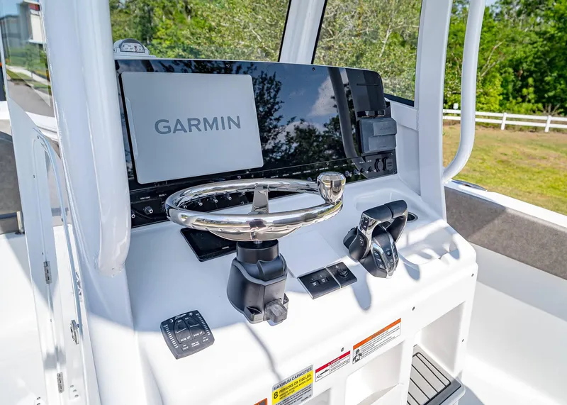 Slide: The Image of 2025 Sea Hunt Gamefish 25 helm with Garmin display and modern controls. - 12