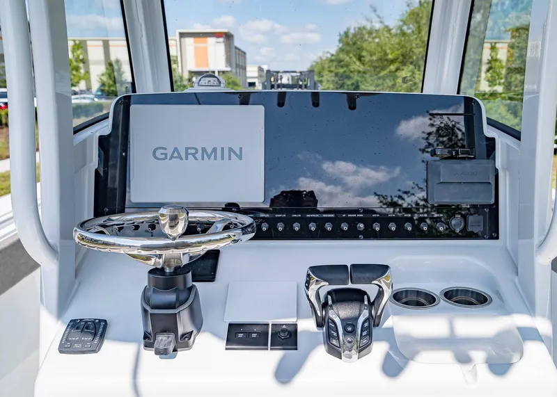 Slide: The Image of 2025 Sea Hunt Gamefish 25 dashboard with Garmin navigation system and modern controls. - 14