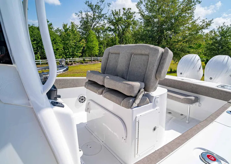 Slide: The Image of 2025 Sea Hunt Gamefish 25 boat interior with cushioned seating and dual engines. - 15