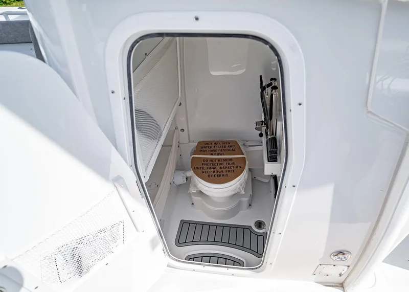 Slide: The Image of 2025 Sea Hunt Gamefish 25 boat interior with compact marine toilet. - 16