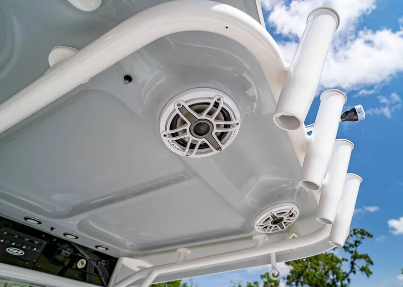 Slide: The Image of 2025 Sea Hunt Gamefish 25 boat roof with speakers and rod holders against blue sky. - 18