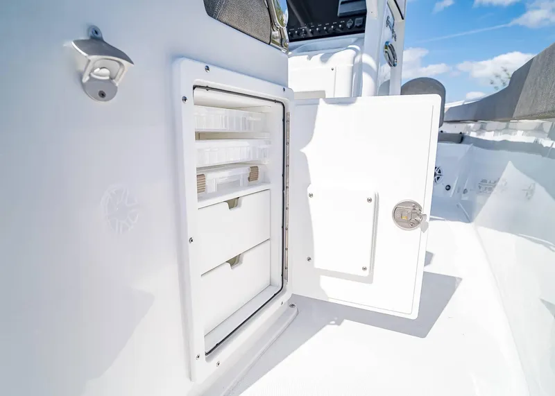 Slide: The Image of Open storage compartment on 2025 Sea Hunt Gamefish 25 boat, showcasing organized interior. - 19