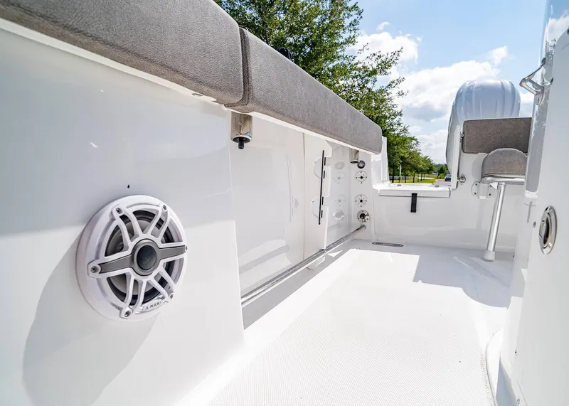 Slide: The Image of 2025 Sea Hunt Gamefish 25 boat interior with seating and speaker, under clear sky. - 22