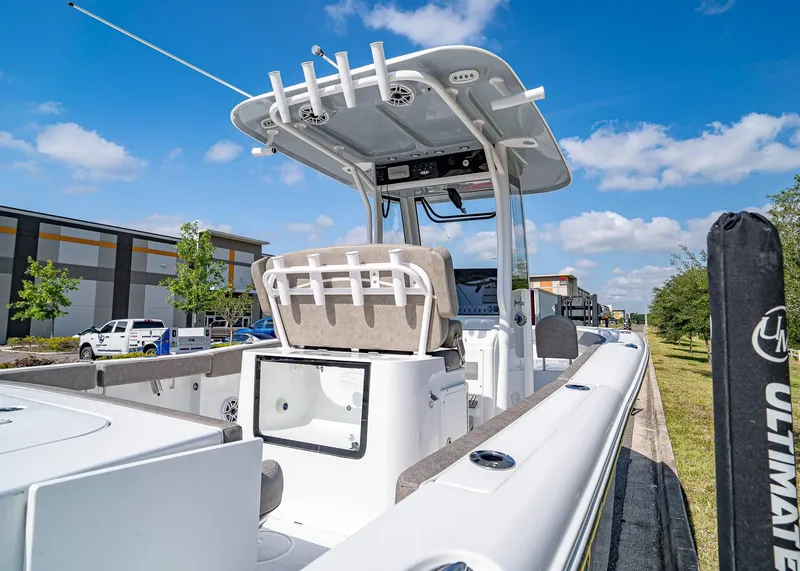 Slide: The Image of 2025 Sea Hunt Gamefish 25 boat, featuring a sleek design and modern amenities, parked outdoors. - 7