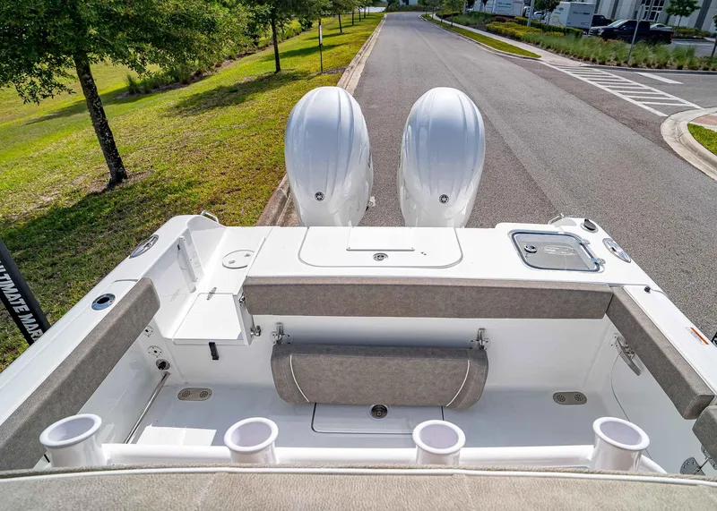 Slide: The Image of 2025 Sea Hunt Gamefish 25 boat with dual engines, spacious deck, and seating area. - 8