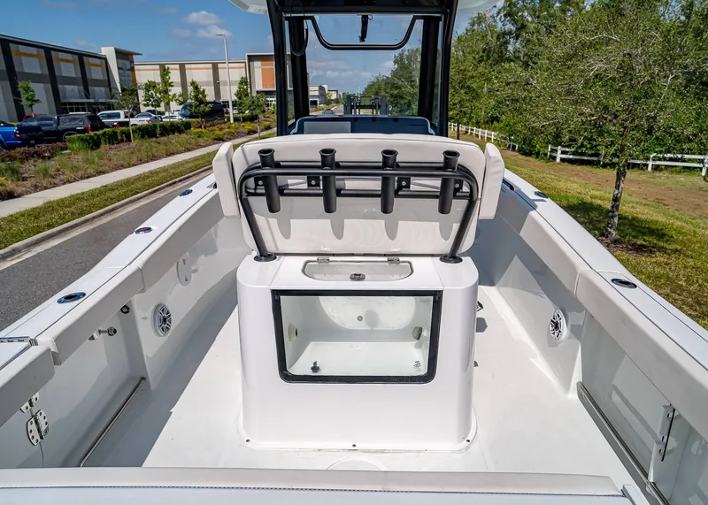 Slide: The Image of 2025 Sea Hunt Gamefish 25 boat interior with rod holders and storage compartment. - 10