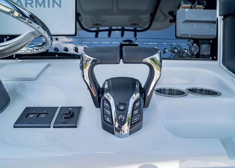 Slide: The Image of Control panel of 2025 Sea Hunt Gamefish 25 boat with modern steering and controls. - 16