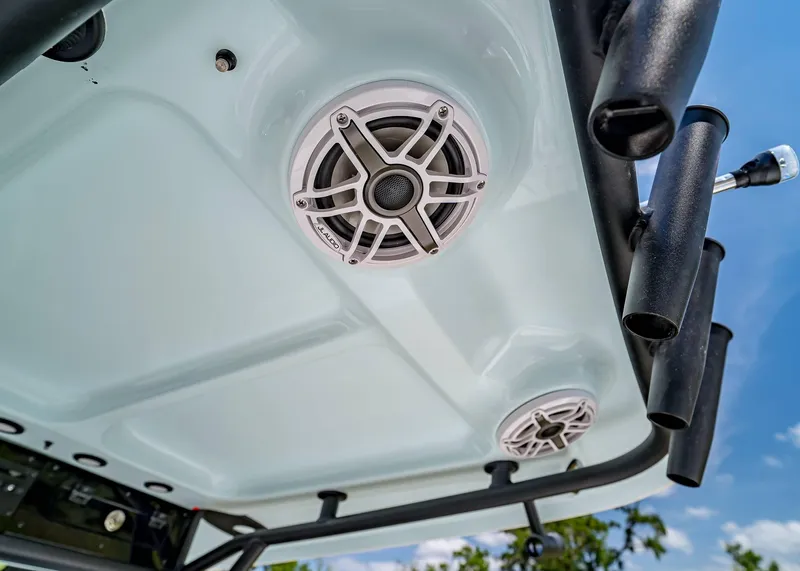 Slide: The Image of 2025 Sea Hunt Gamefish 25 boat speakers and rod holders under blue sky. - 18