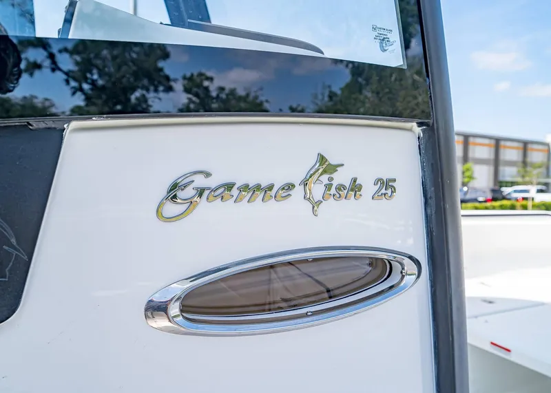 Slide: The Image of 2025 Sea Hunt Gamefish 25 boat logo and window detail. - 19