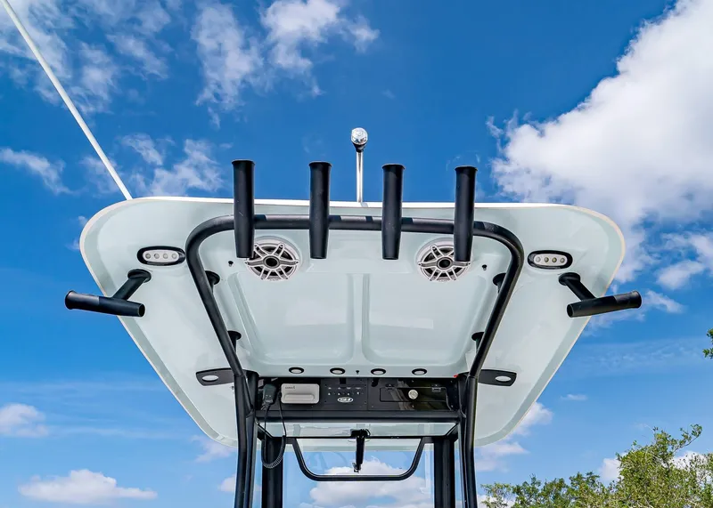 Slide: The Image of 2025 Sea Hunt Gamefish 25 boat top view with rod holders against blue sky. - 21