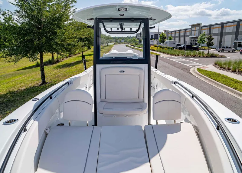 Slide: The Image of 2025 Sea Hunt Gamefish 25 boat interior with seating, parked outdoors. - 29