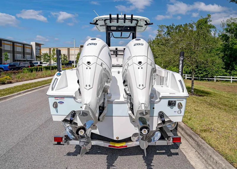 Slide: The Image of 2025 Sea Hunt Gamefish 25 boat with dual outboard engines on a trailer. - 5