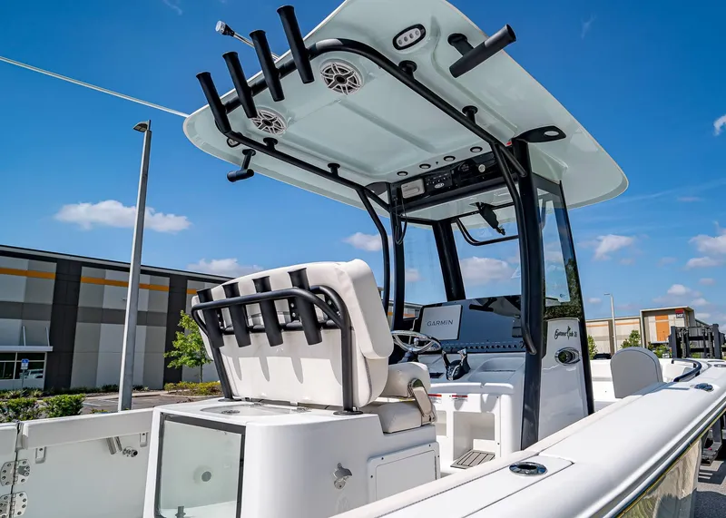 Slide: The Image of 2025 Sea Hunt Gamefish 25 boat with T-top and Garmin electronics, docked outdoors. - 6