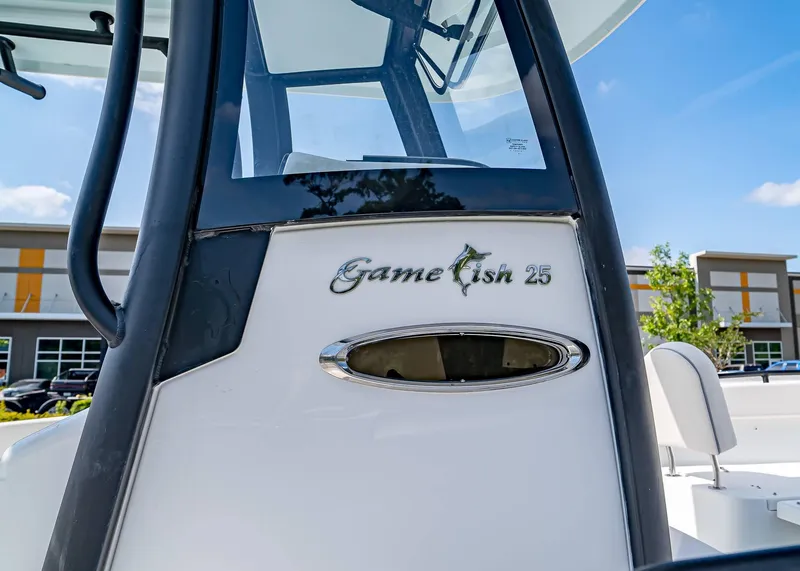 Slide: The Image of 2025 Sea Hunt Gamefish 25 boat, close-up of logo and design details. - 7