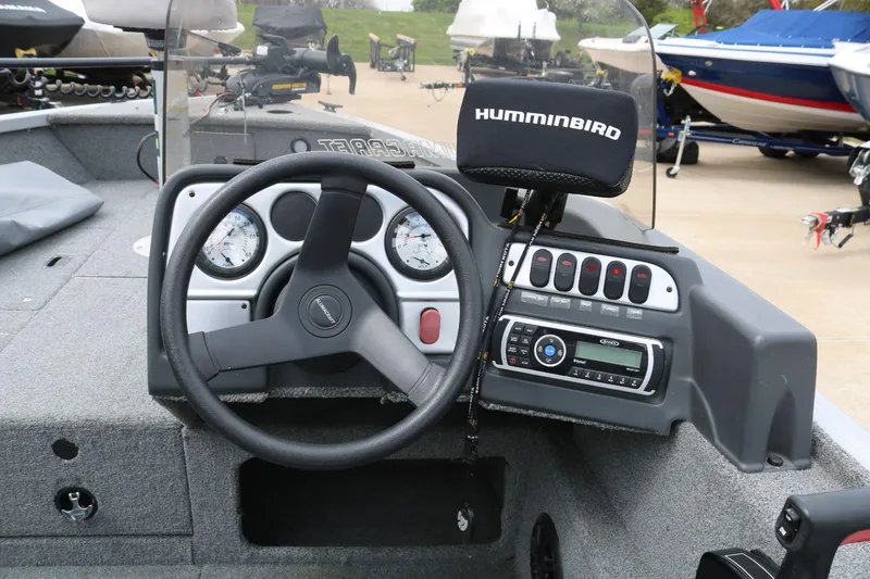 Slide: The Image of 2014 Alumacraft Competitor 165 CS boat dashboard with steering wheel and Humminbird fish finder. - 16