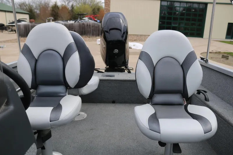 Slide: The Image of 2014 Alumacraft Competitor 165 CS boat interior with two cushioned seats and motor. - 20