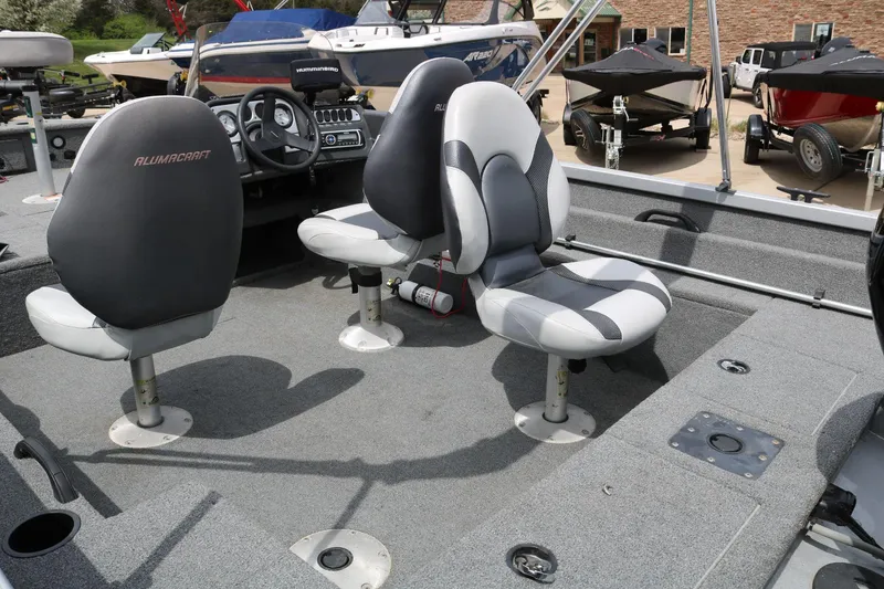 Slide: The Image of 2014 Alumacraft Competitor 165 CS boat interior with two swivel seats and steering console. - 21