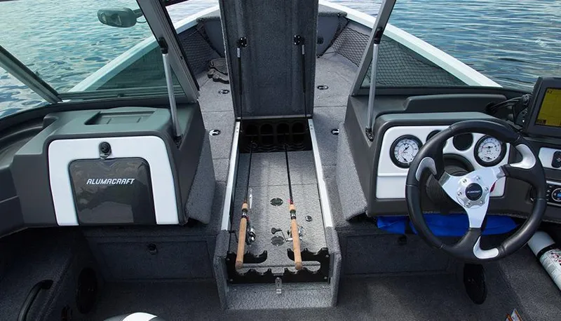 Slide: The Image of 2014 Alumacraft Competitor 165 CS boat interior with rod storage and steering console. - 32
