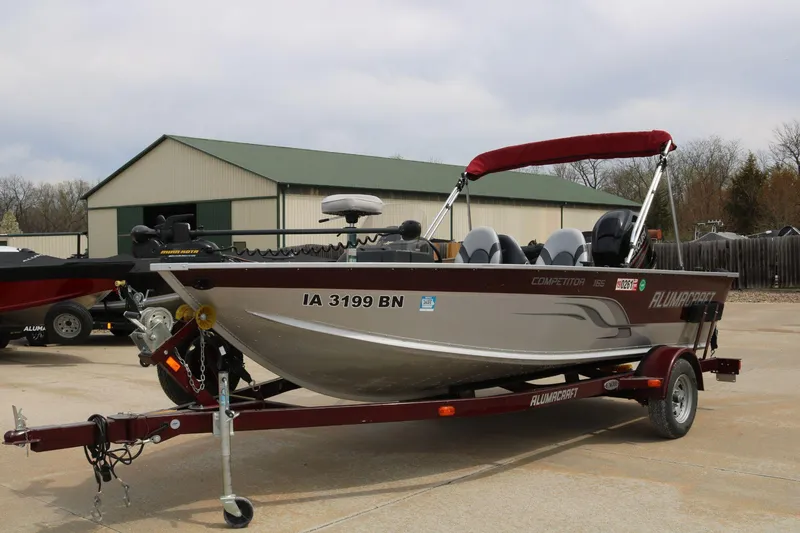 Slide: The Image of 2014 Alumacraft Competitor 165 CS boat on trailer, parked outdoors. - 4