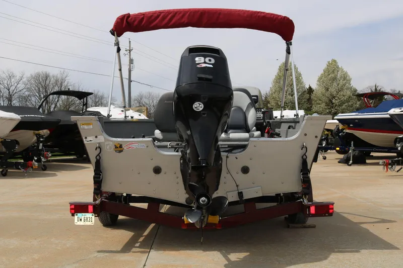 Slide: The Image of 2014 Alumacraft Competitor 165 CS boat with outboard motor, parked on a trailer. - 7