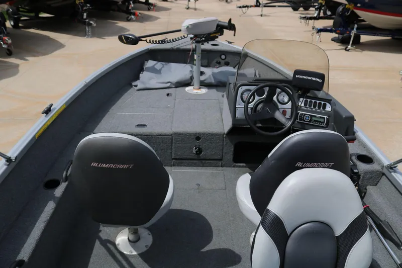 Slide: The Image of 2014 Alumacraft Competitor 165 CS boat interior with steering console and seating. - 9