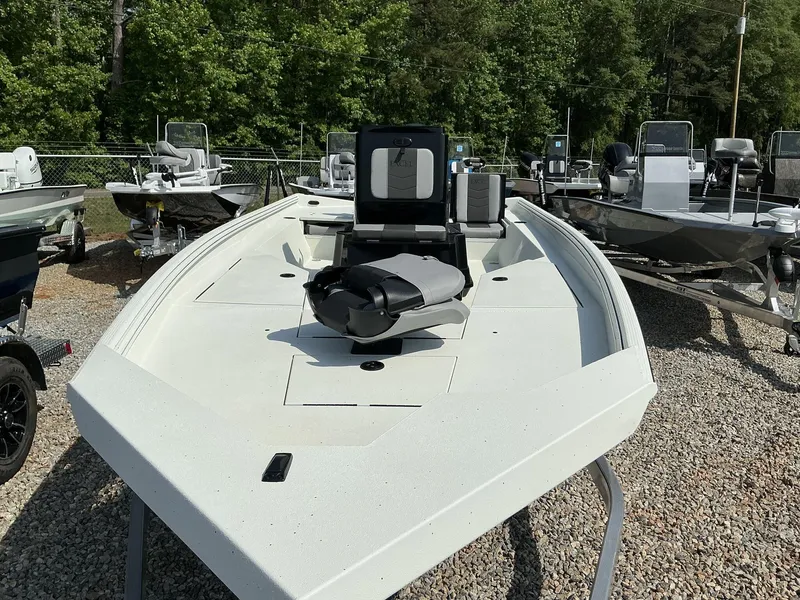 Slide: The Image of 2025 Excel Bay Pro 220 ELITE boat displayed outdoors with other boats. - 10