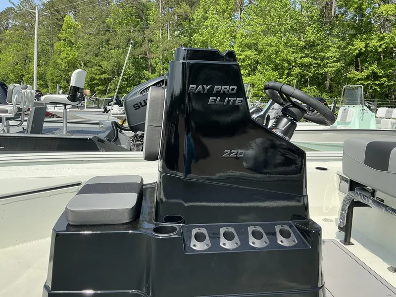Slide: The Image of 2025 Excel Bay Pro 220 Elite boat console with steering wheel and seating. - 5