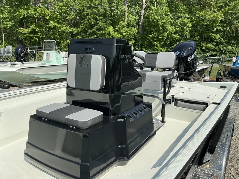 Slide: The Image of 2025 Excel Bay Pro 220 ELITE boat with seating and Suzuki outboard motor, displayed outdoors. - 7