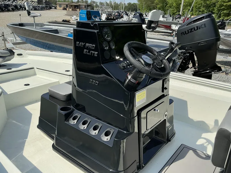 Slide: The Image of 2025 Excel Bay Pro 220 Elite boat console with Suzuki engine, featuring sleek design and controls. - 8