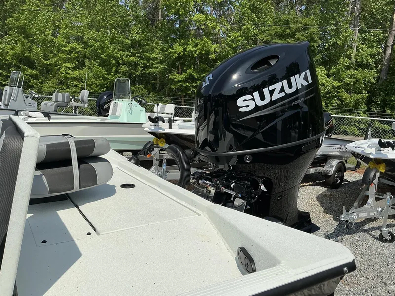 Slide: The Image of 2025 Excel Bay Pro 220 ELITE boat with Suzuki outboard motor in a wooded area. - 9