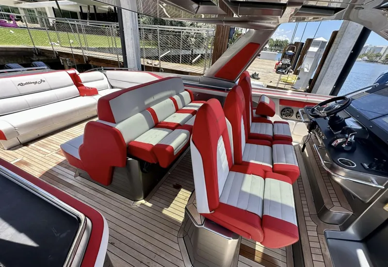Slide: The Image of 2020 Cigarette 59 Tirranna boat interior with red and gray seating, docked by the water. - 10